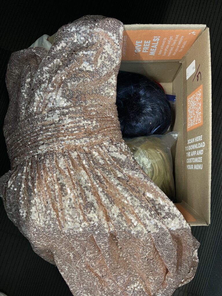 Golden sequin gown and wigs from a workplace clothes swap